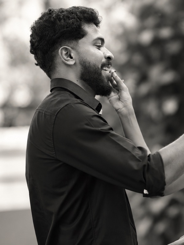 Abhijith smiling in a black shirt